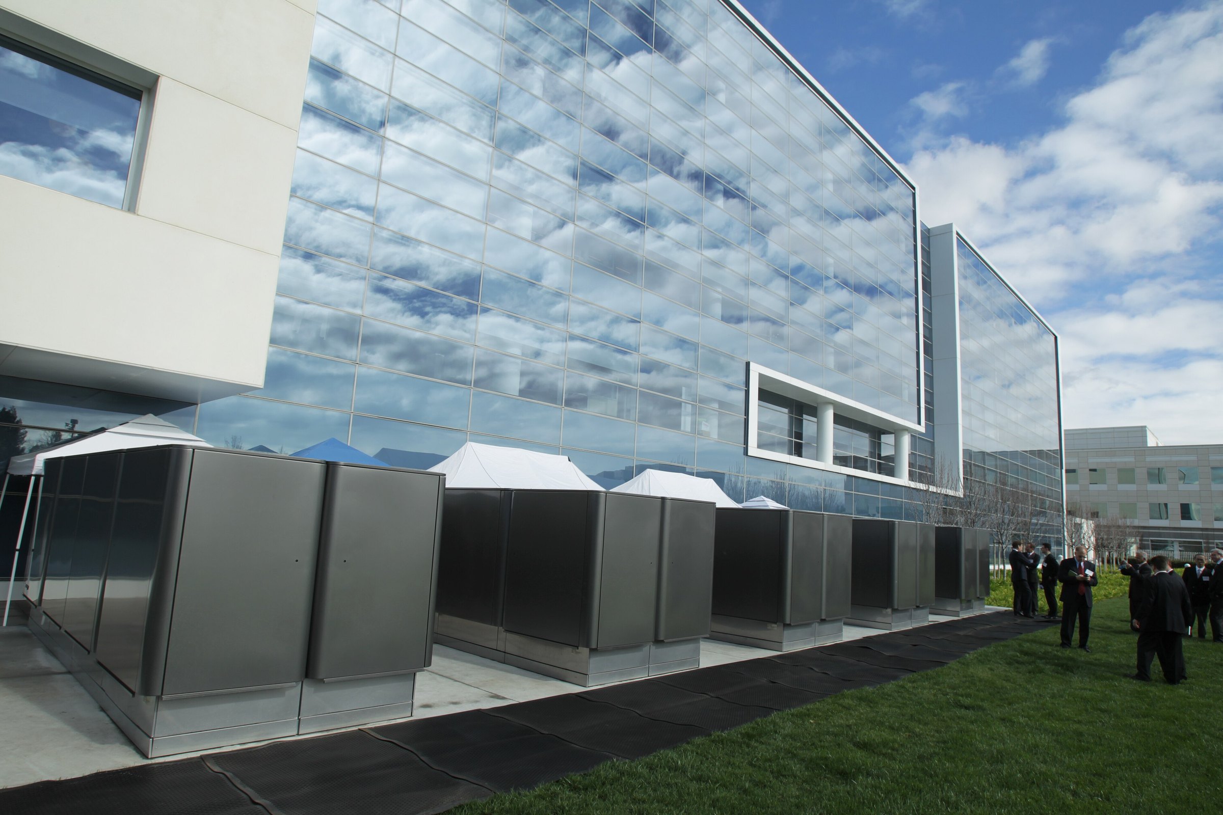 A row of Bloom Energy Servers beside a glass office building at eBay's San Jose campus, 2010